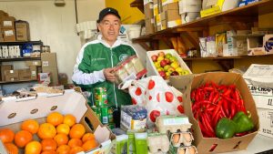 Man standing with fresh produce in pantry